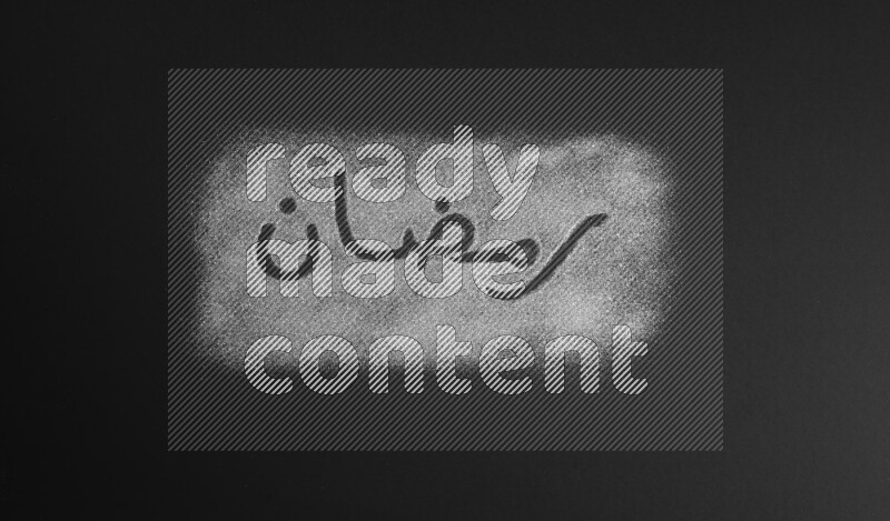 A word written with silver glitter on black background