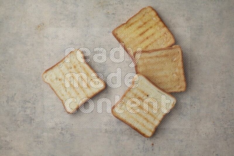 Toasted white Toast slices on a light blue textured background