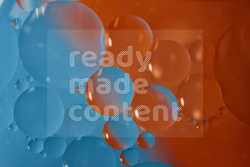 Close-ups of abstract oil bubbles on water surface in shades of blue and orange