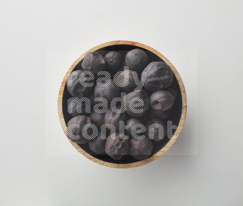 Top-view shot of dried lime (loomi) in a container on white background