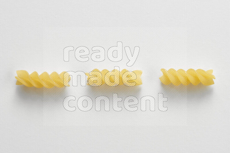 Fusilli pasta on white background