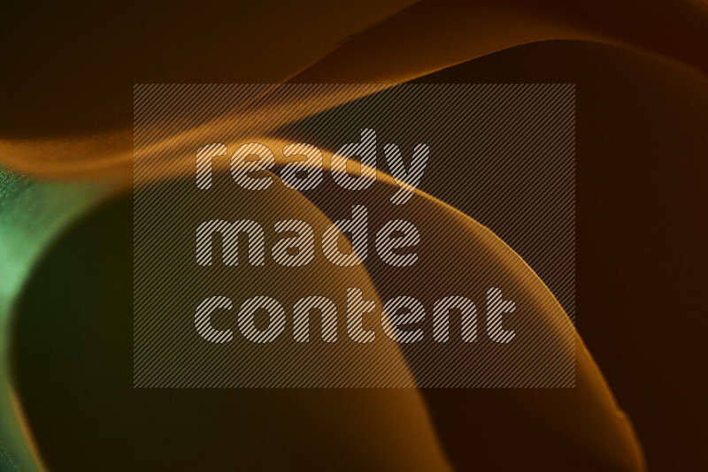 An abstract art piece displaying smooth curves in green and orange gradients created by colored light