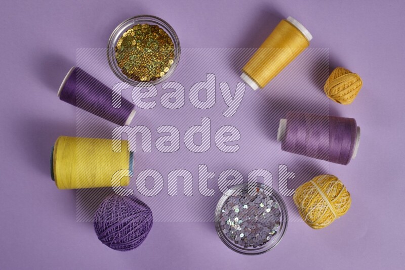 A yellow and purple collection of sewing and tailoring tools arranged on a purple background