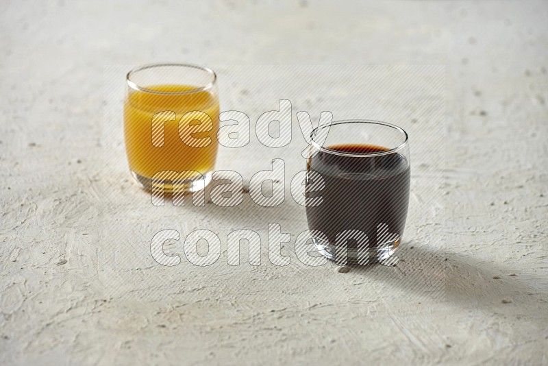 Cold drinks in a glass cup such as water, tamarind, qamar eldin, sobia, milk and hibiscus on textured white background