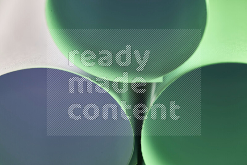 The image shows an abstract paper art with circular shapes in varying shades of green