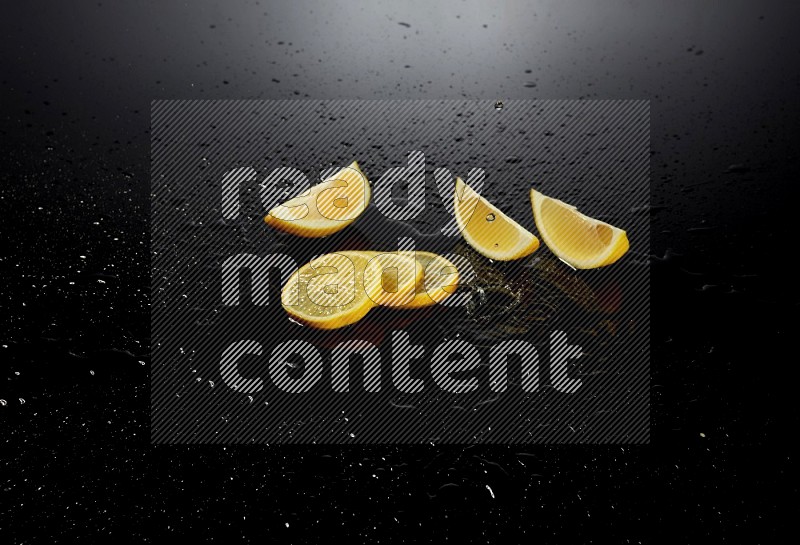 Lemon slices with water drops, and droplets on black background