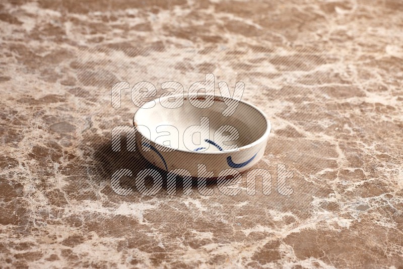 Multicolored Pottery Bowl on Beige Marble Flooring