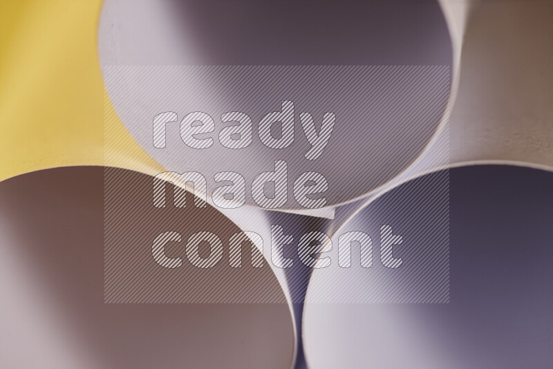 The image shows an abstract paper art with circular shapes in varying shades of grey and warm tones