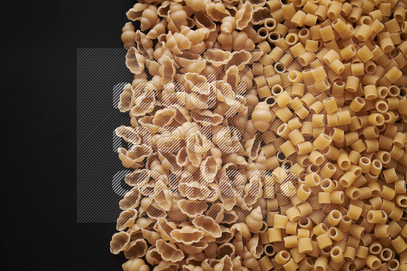 Different pasta types on black background