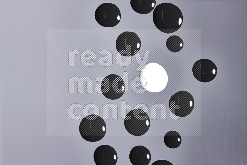 Close-ups of abstract white and black paint droplets on the surface