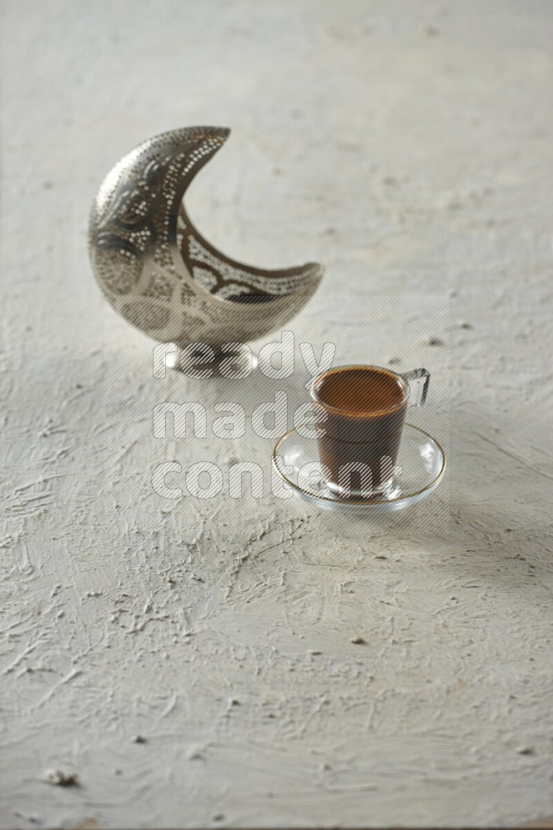 A silver lantern with different drinks, dates, nuts, prayer beads and quran on textured white background