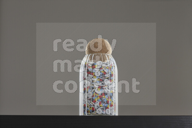 Buttons in a glass jar on black background
