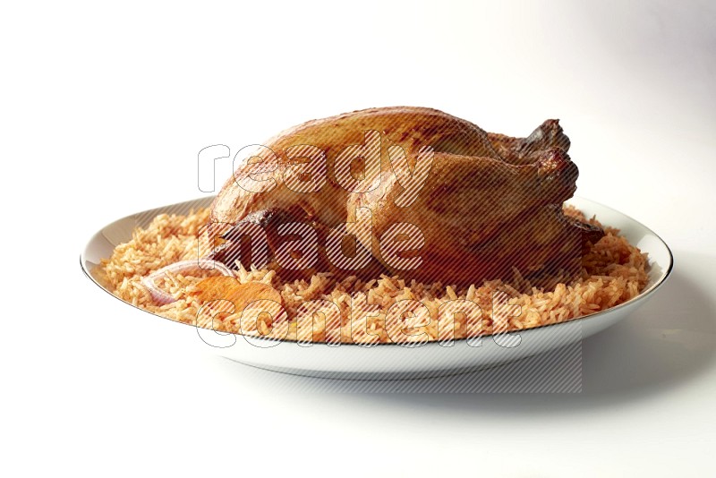 red basmati Rice with whole roasted chicken on a white plate with a silver rim direct on white background