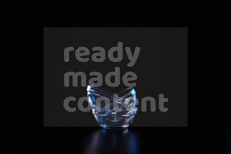 Glassware with rim light in blue and white against black background