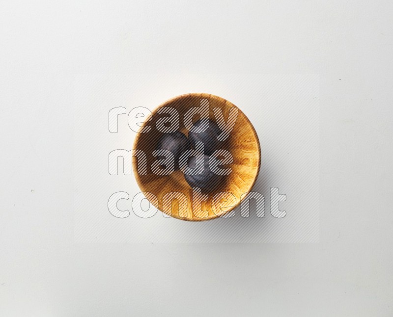 Top-view shot of dried lime (loomi) in a container on white background