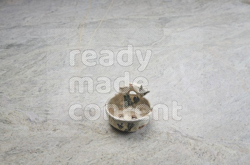 A Pottery Soap Dish On Grey Marble Flooring