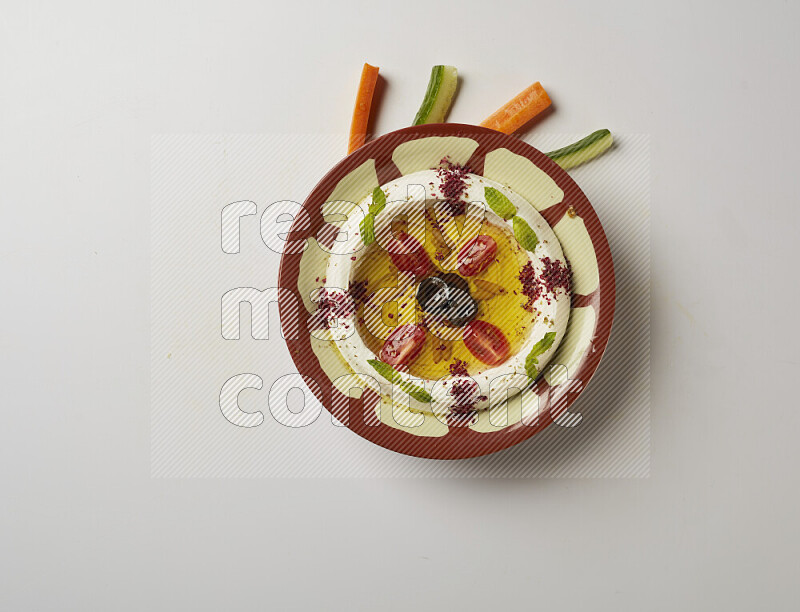 Lebnah garnished with Cherry tomato, mint & sumak  in a traditional plate on a white background