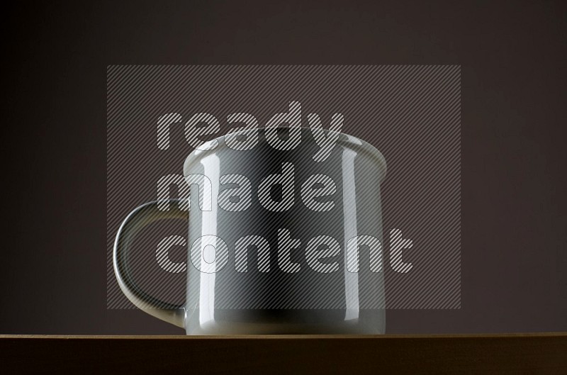 Low angle shot of a grey cup on grey background