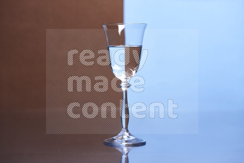 The image features a clear glassware filled with water, set against brown and light blue background