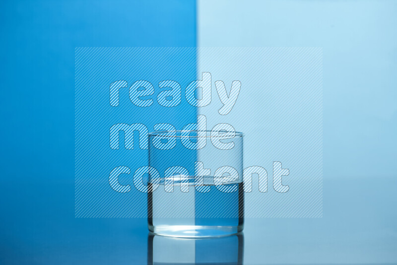 The image features a clear glassware filled with water, set against blue and light blue background