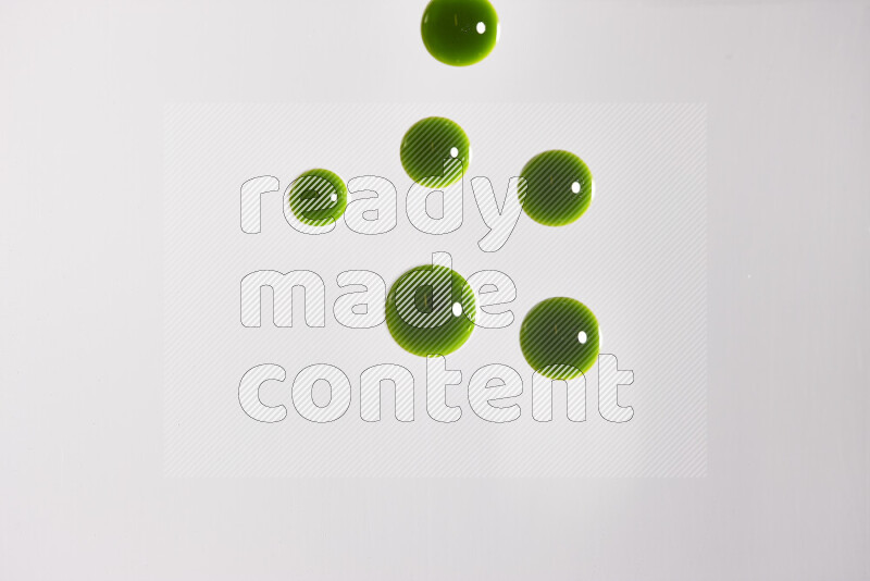 Close-ups of abstract green paint droplets on the surface