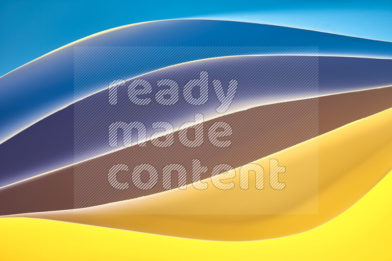 This image showcases an abstract paper art composition with paper curves in blue and yellow gradients created by colored light