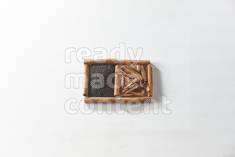 2 squares of cinnamon sticks full of black seeds and cinnamon on white flooring
