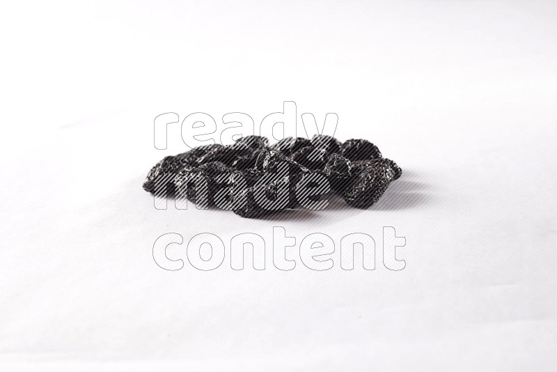 Dried plums on white background