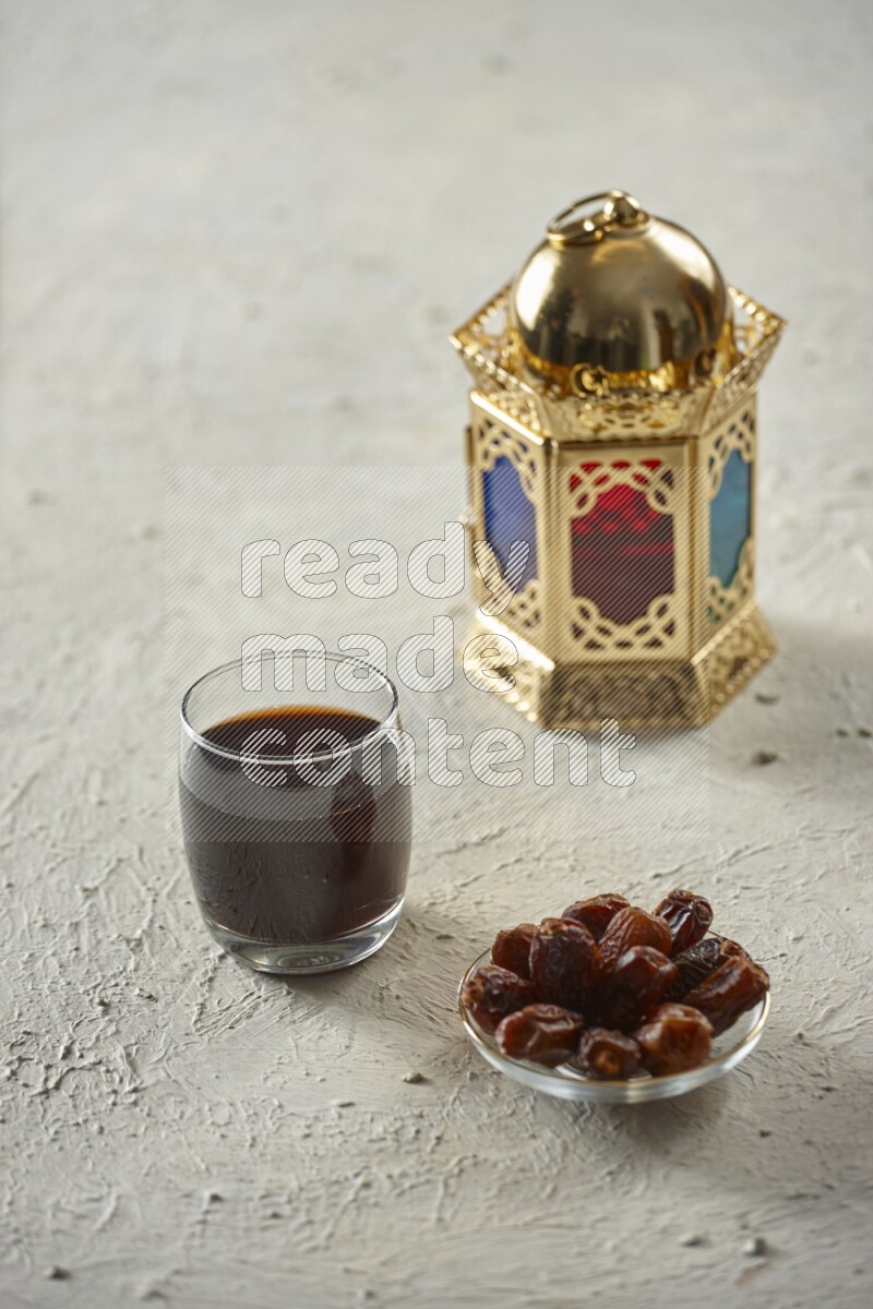 A golden lantern with different drinks, dates, nuts, prayer beads and quran on textured white background