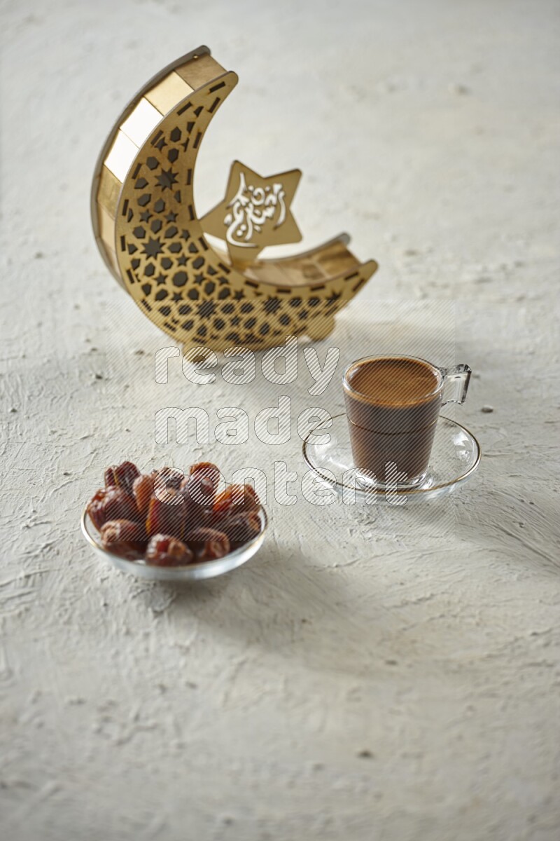 A wooden golden crescent lantern with different drinks, dates, nuts, prayer beads and quran on white background