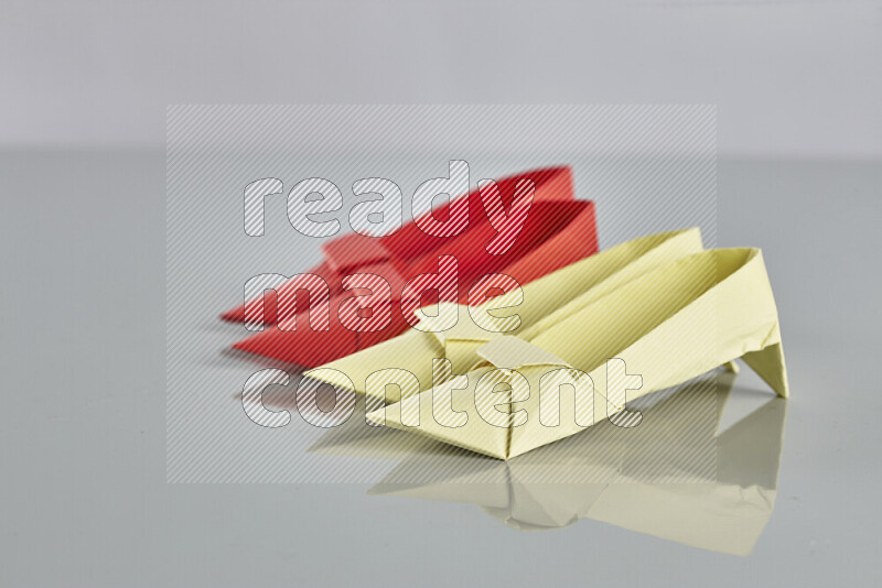 Origami shoes on grey background