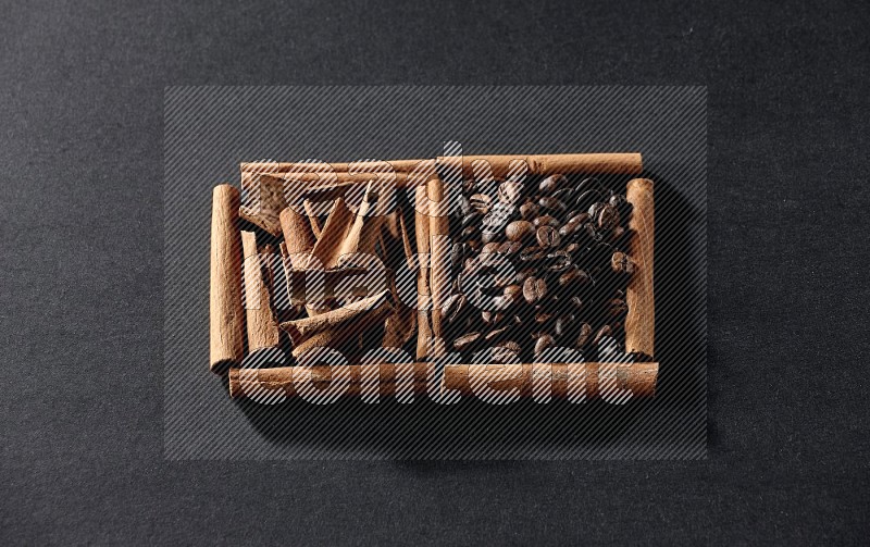 2 squares of cinnamon sticks full of coffee beans and cinnamon on black flooring