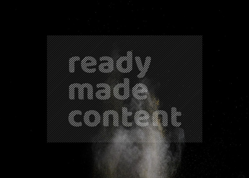 A side view of brown powder explosion on black background