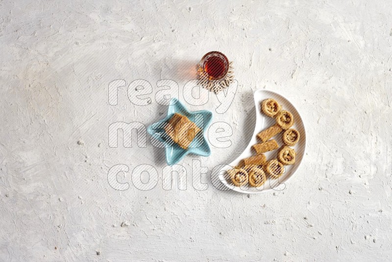 Oriental sweets in a pottery plate with drinks in a light setup