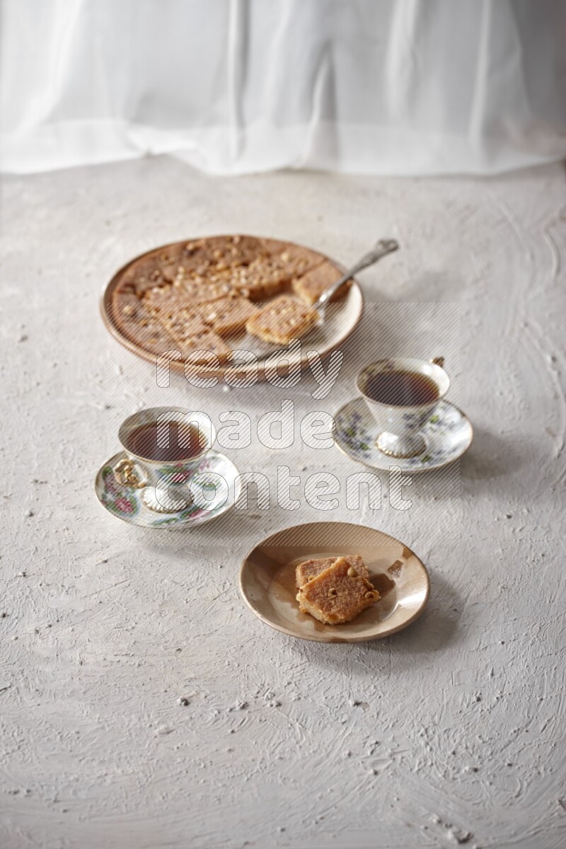 Basbousa with tea in a light setup