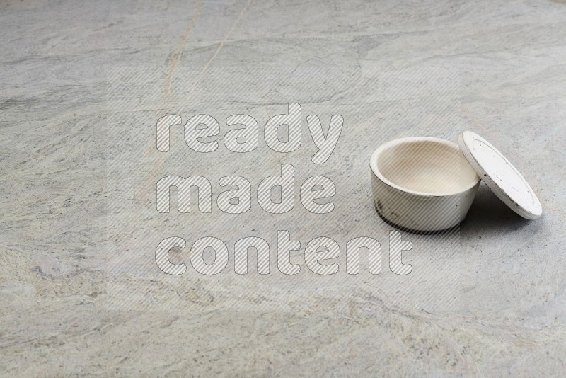 White Pottery Bowl On Grey Marble Flooring