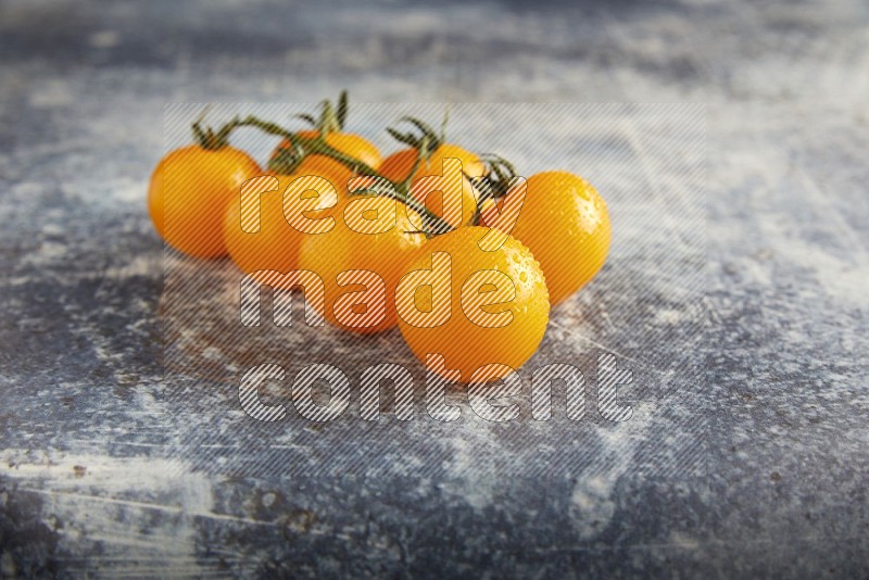 yellow cherry tomato vein on a textured rusty blue background 45 degree