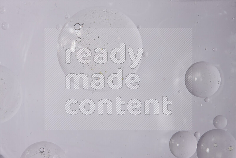 Abstract oil droplets in a water surface on white background