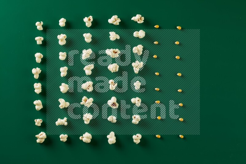 Popcorn flakes and seeds on a green background in a top view shot