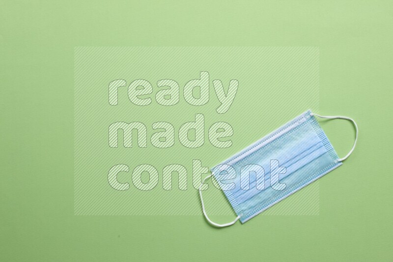 A face mask on green background
