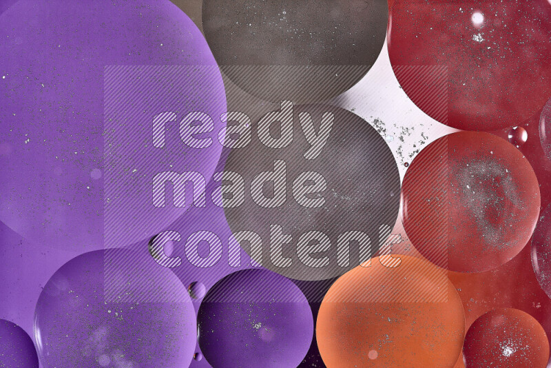 Close-ups of abstract oil bubbles on water surface in shades of purple, brown, orange and red