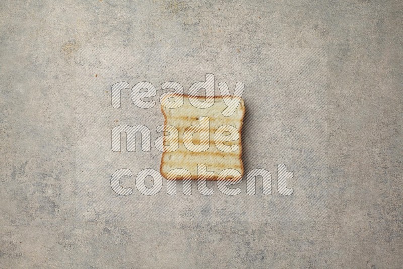 Toasted white Toast slices on a light blue textured background