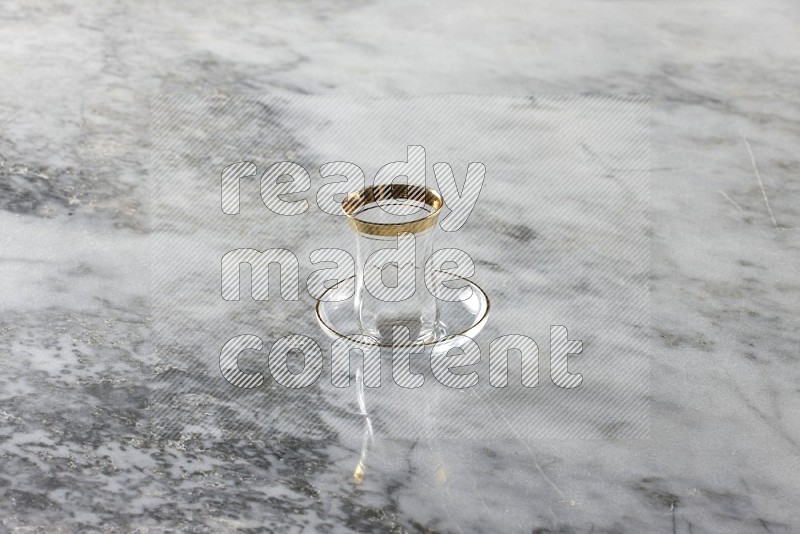 A glassware such as a coffee pot and a cup on grey marble background