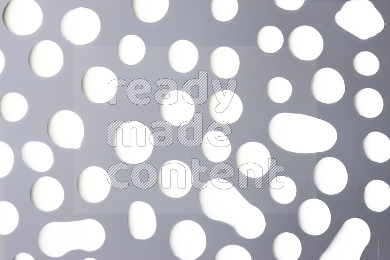 Close-ups of abstract white paint droplets on the surface