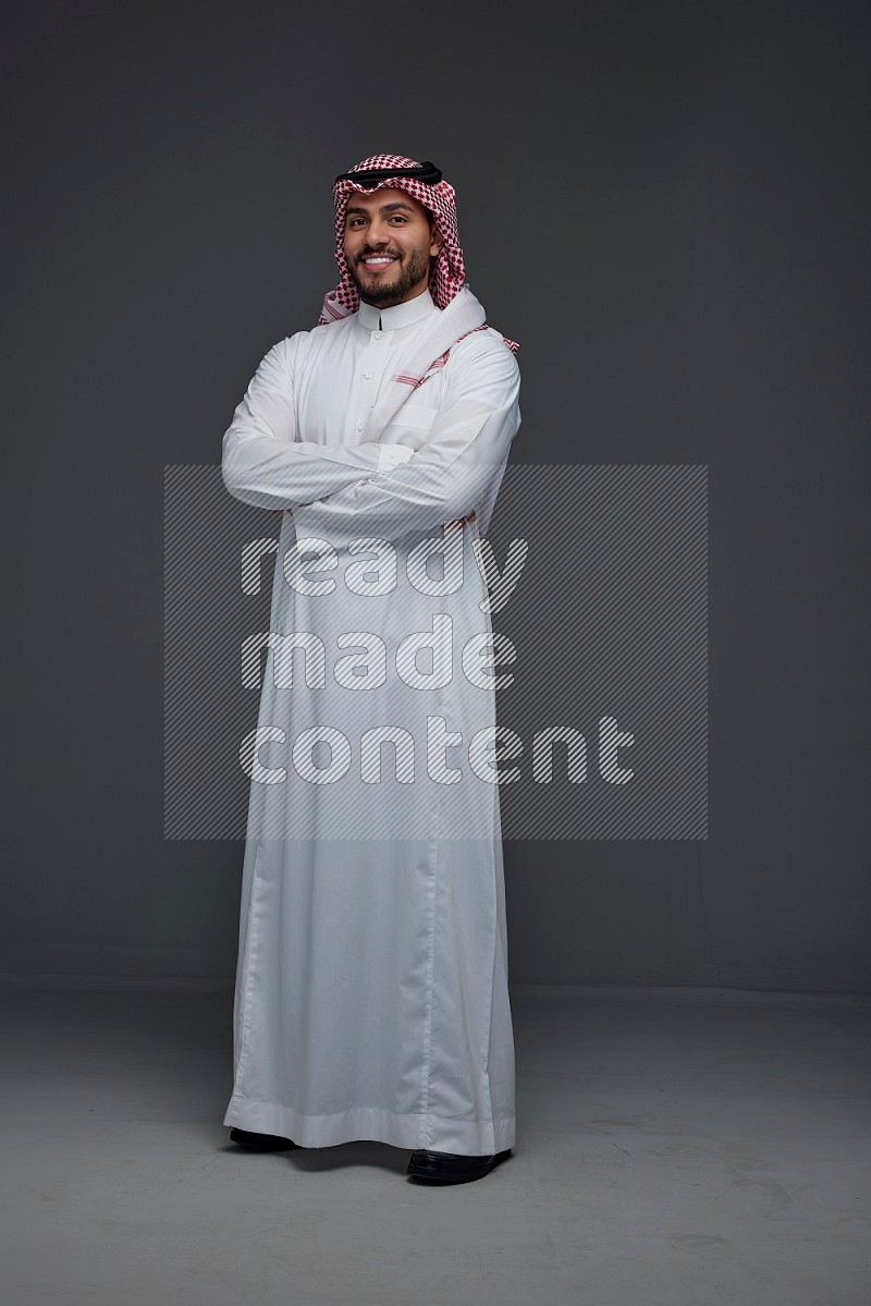 A Saudi man wearing Thobe and Shmagh standing in different poses eye level on a gray background