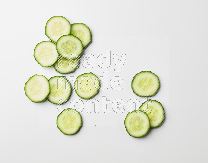 Multiple cucumber slices on white background