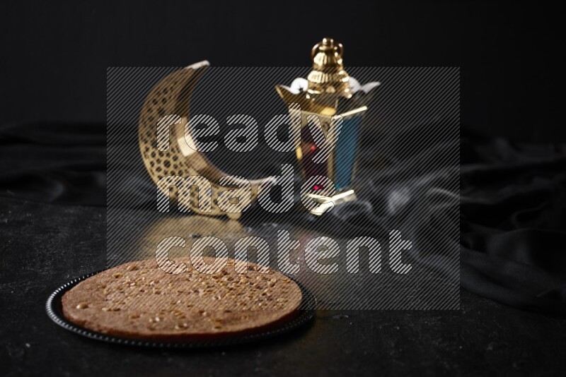 Basbousa with lanterns in a dark setup