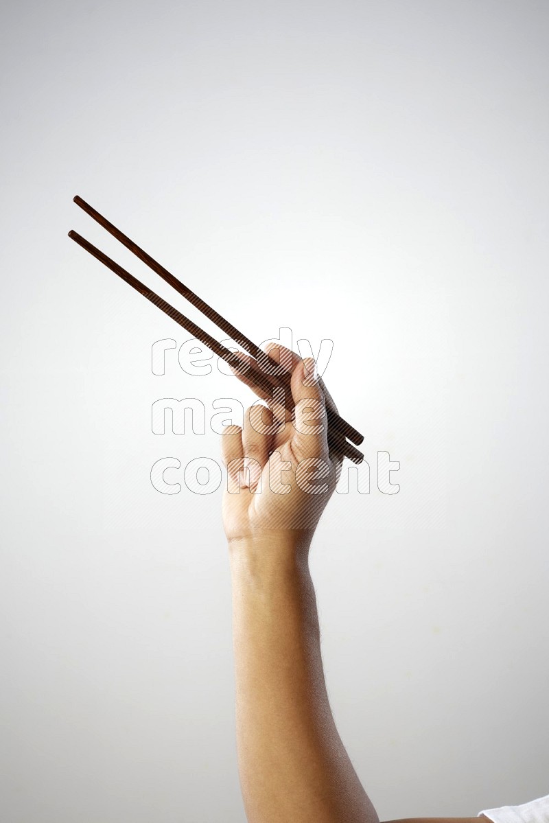 Male Hand Holding Chop Stick on white background