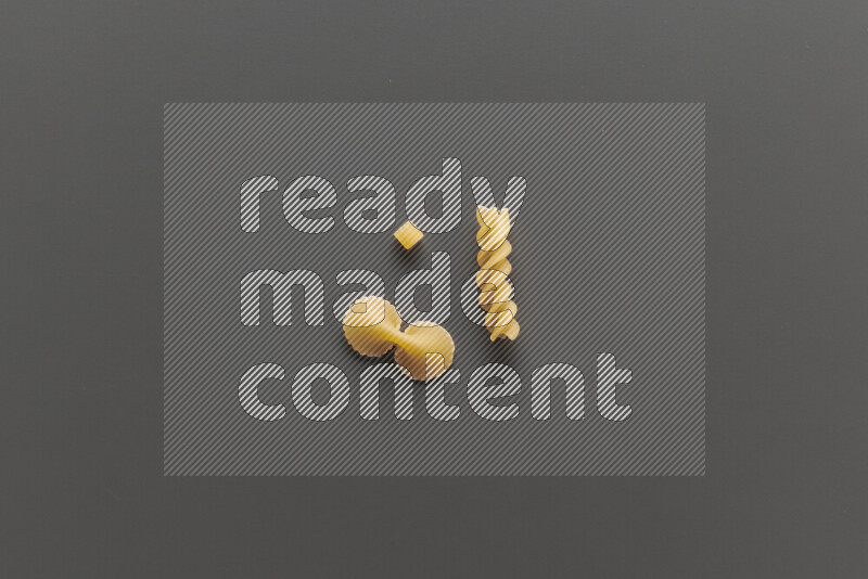 Different pasta types on grey background