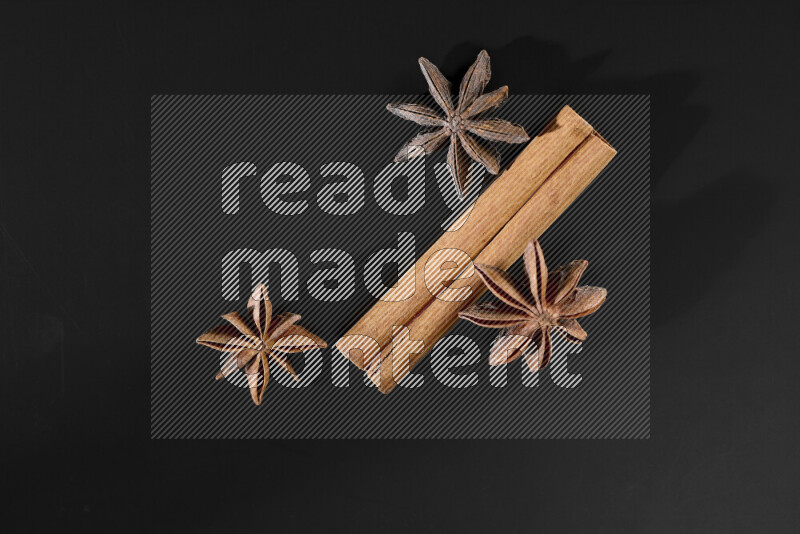 Cinnamon sticks and star anise on black background